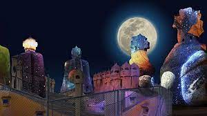 Rooftop statues lit up under a full moon