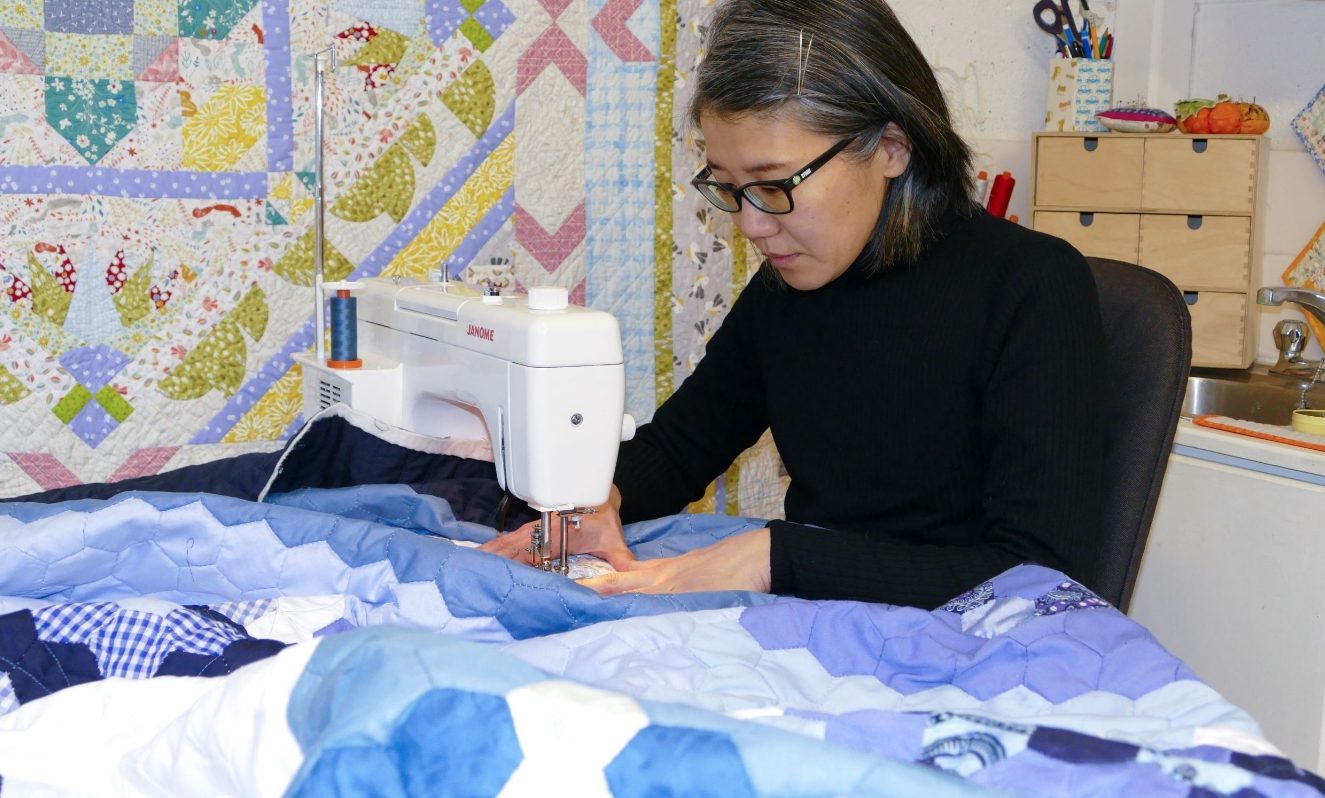 Tomomi expertly using a sewing machine