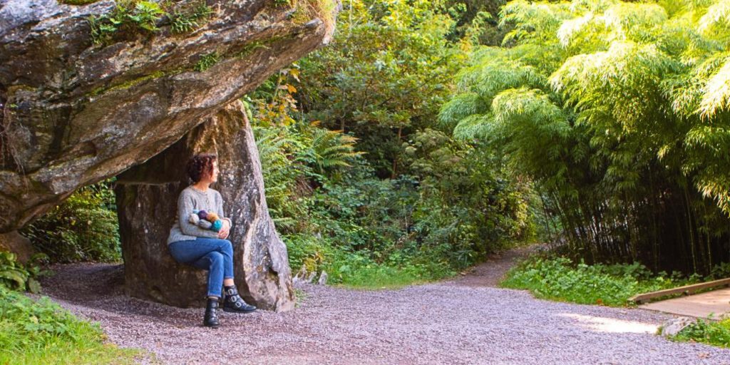 Carol sitting in a forest