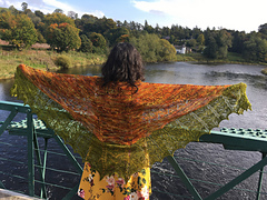 Woman with shawl facing out over bridge and Loch.