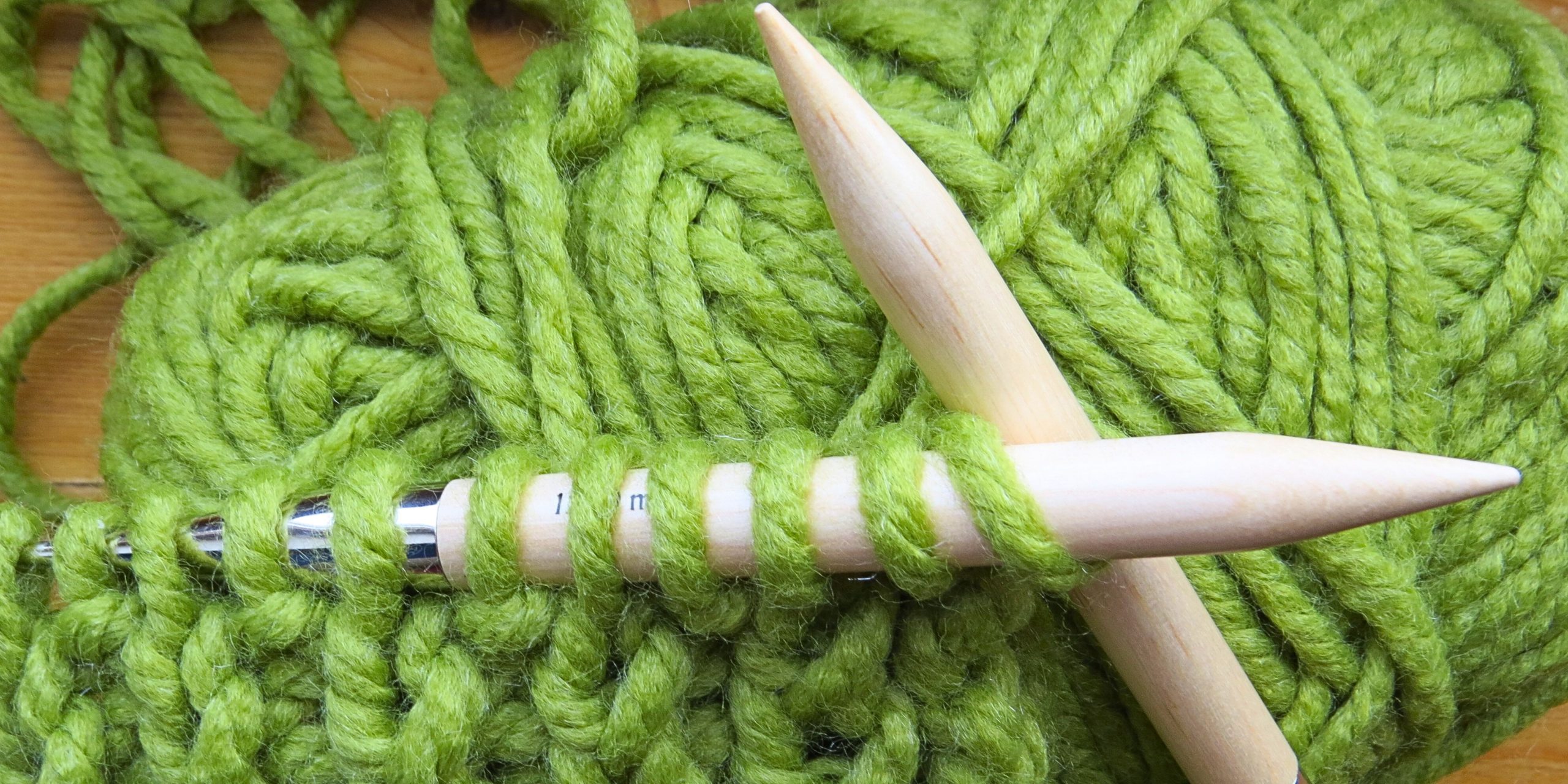Knitting needles and green yarn
