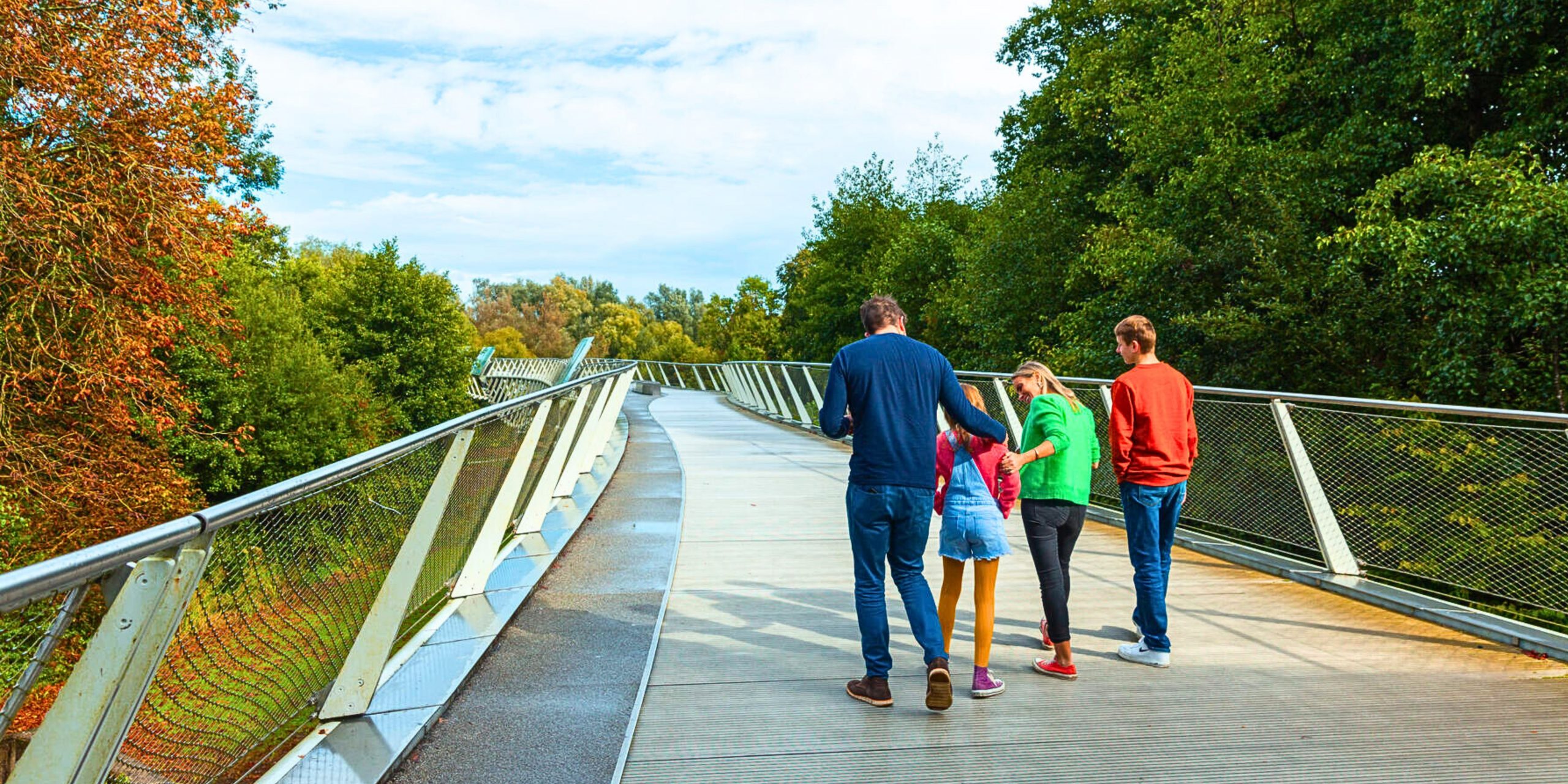 Family walking along bridge on UL campus