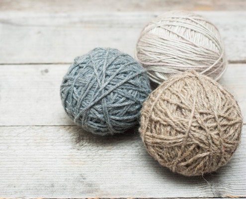 Balls of yarn on wooden surface