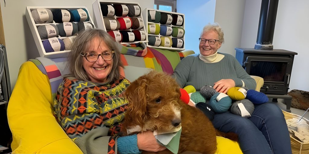Woman on sofa with dog surrounded by yarn
