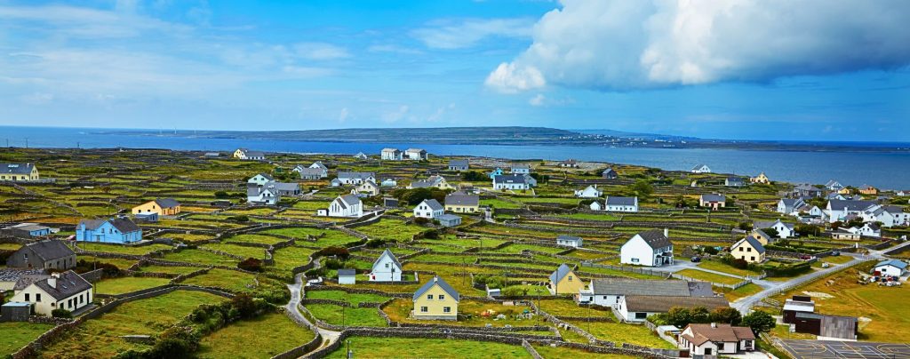 Aerial view of island and houses with blue sky
