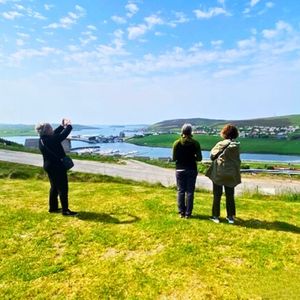 Group of women taking scenic pictures of landscape