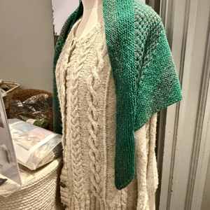 Knitted Aran jumper and shawl on mannequin