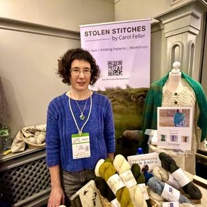 Woman with display of yarn and knitting