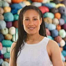 Woman with balls of yarn backdrop