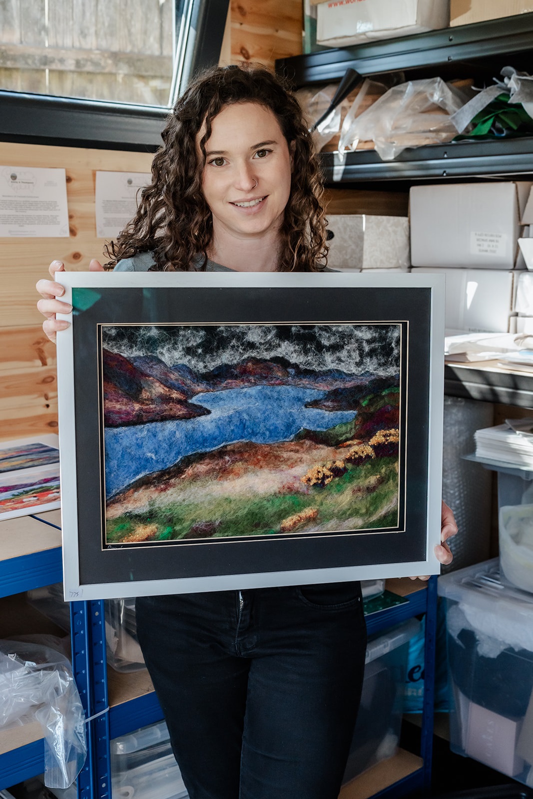 Woman holding needle felting painting