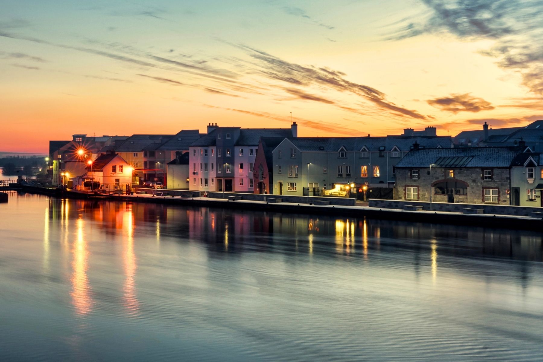 Town on the river at dusk with lights